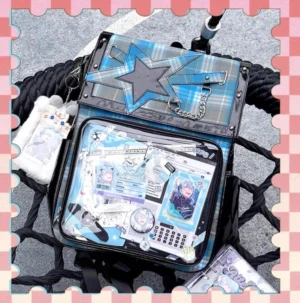 Blue-green tartan star ita backpack overhead flat lay with plush charm accessories on black textured background