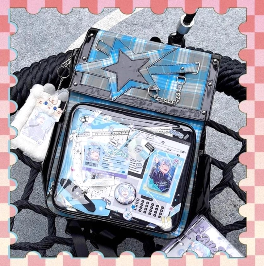 Blue-green tartan star ita backpack overhead flat lay with plush charm accessories on black textured background