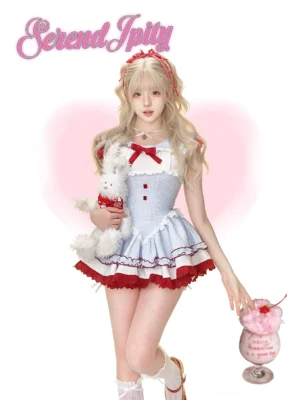 Blue plaid Jirai Kei sweet gyaru dress front view with Peter Pan collar and flutter shoulders on model with pink heart backdrop