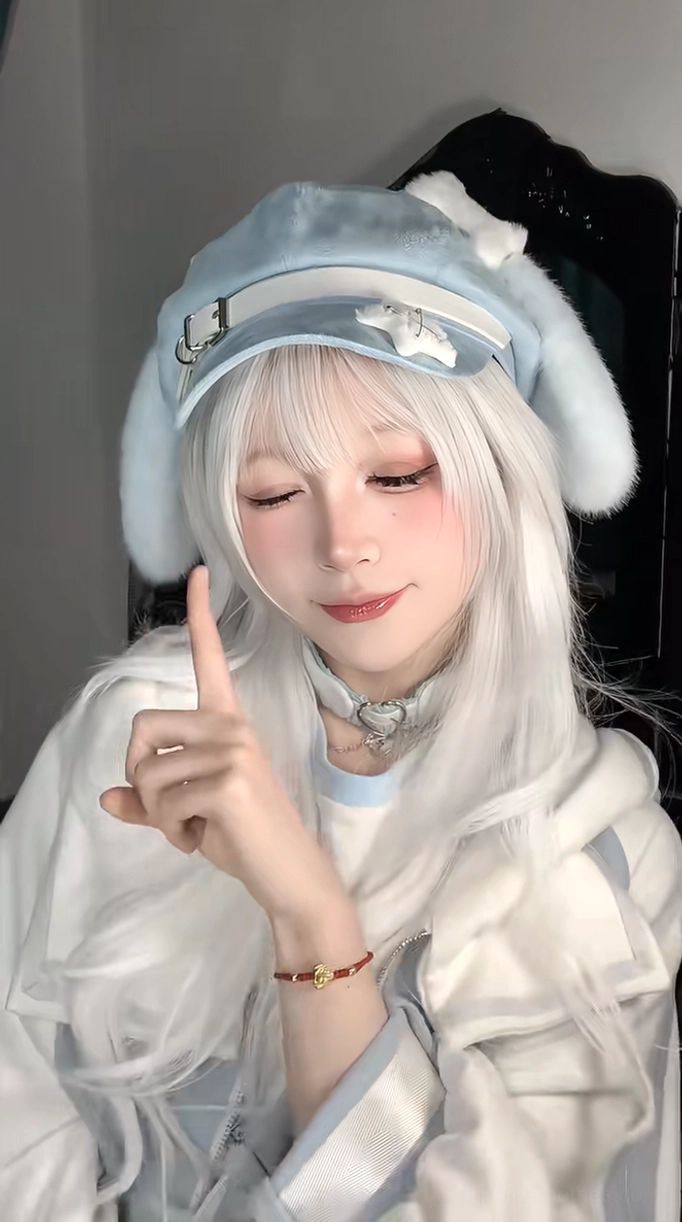 Frontal headshot of blue puppy ear beret on model with white hair and silver choker, one finger pointing gesture for playful Tenshi aesthetic