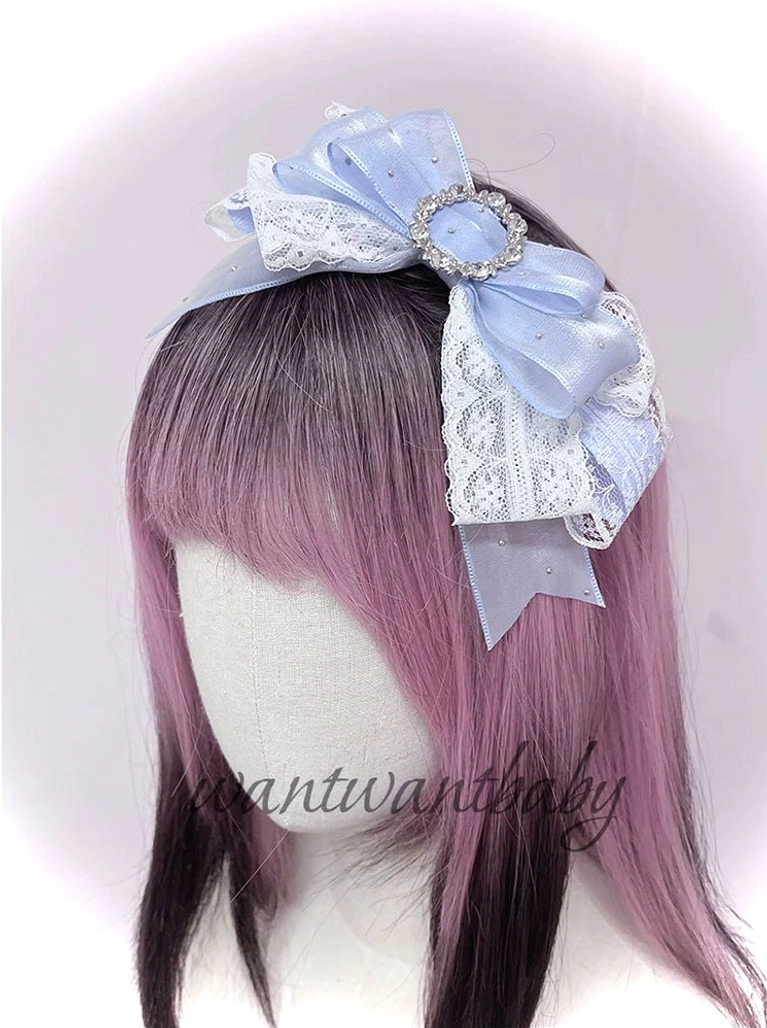 Pastel blue rhinestone bow jirai kei headband with lace trim and sparkling buckle on mannequin right front angle view
