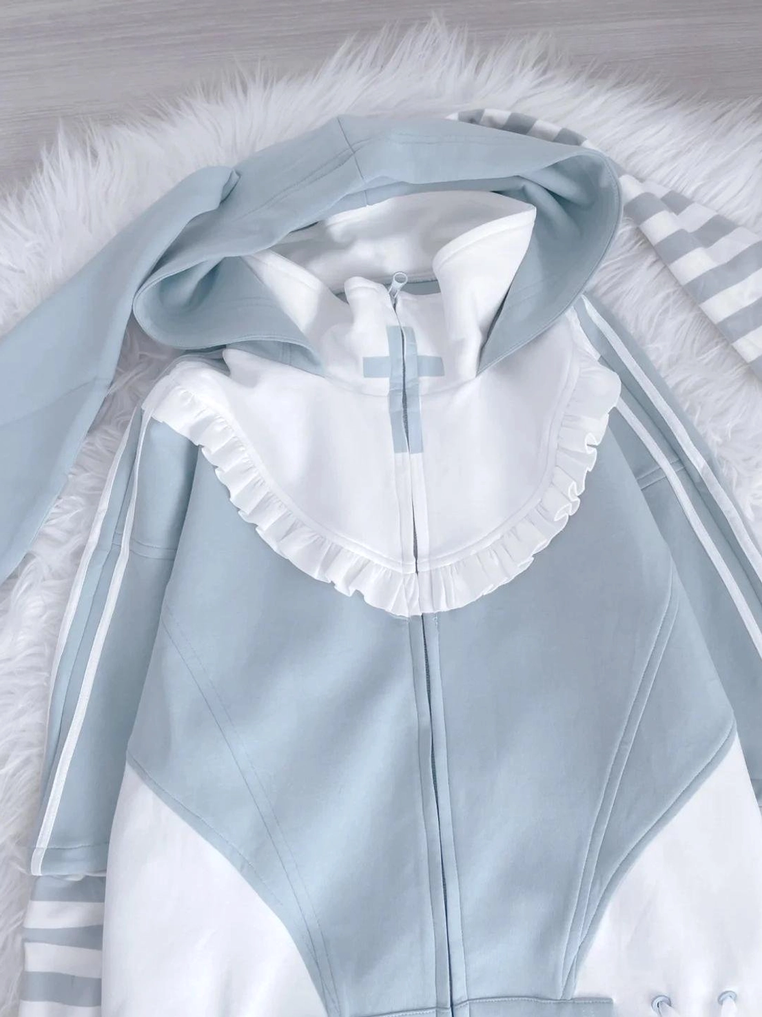 Size comparison and fit guide for blue Tenshi Kaiwai hoodie on different body types showing sizing options
