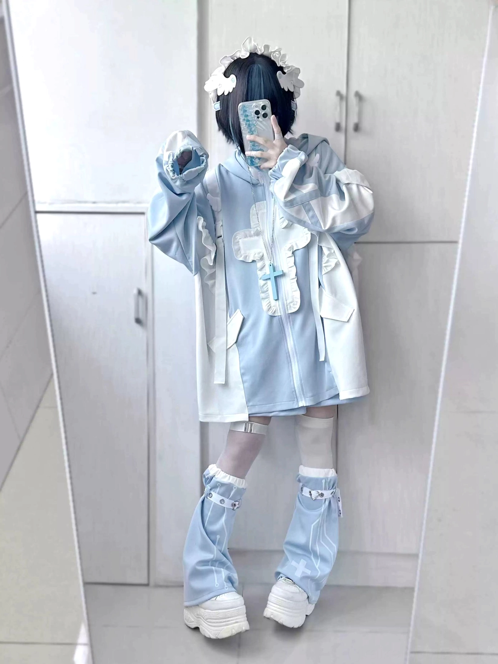 Front full-body mirror selfie of pastel blue and white cat ear tenshi coat with flounced details, coordinated shorts, and leg warmers styled with flower hair clips and white platform shoes