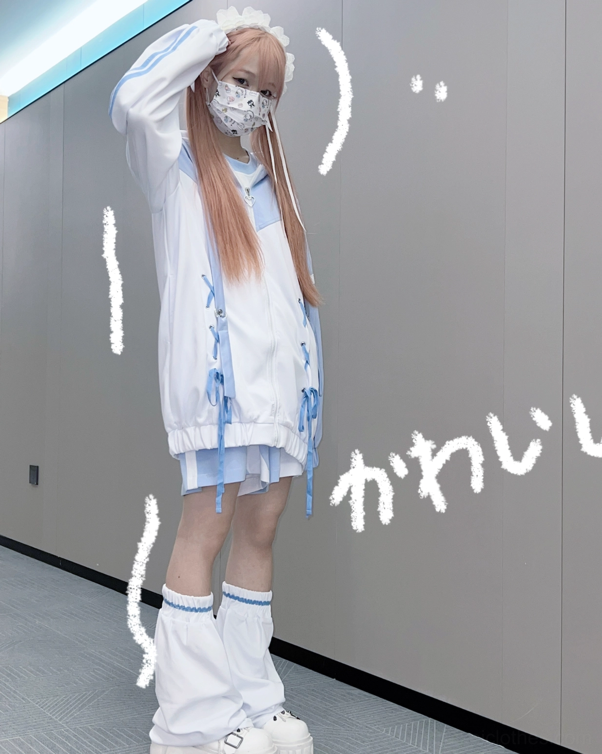 Blue-white lace-up oversized Jirai Kei hoodie set with cross-lacing, matching mini skirt, and loose leg warmers on blonde twin-tail model standing indoors