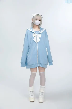 Baby blue Jirai Kei sailor collar embroidered zip jacket with white bow and heart zipper, light gray-haired model studio photography