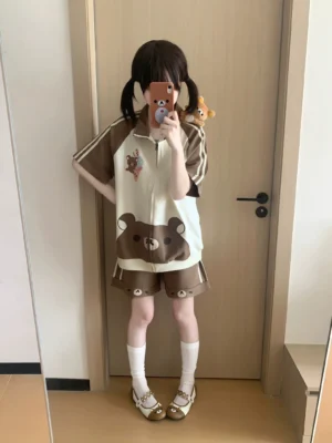 Brown cream colored bear ice cream jirai kei loungewear set with side stripe details on model in mirror reflection