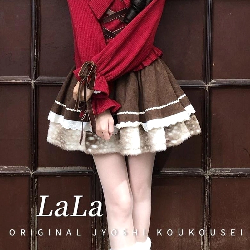 Brown tiered ruffled skirt with soft fuzzy bottom layer, scalloped edging, and elastic waistband, displaying full volume and romantic jirai kei silhouette