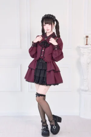 Burgundy gothic blouse with lace shoulder cutouts and tiered ruffled hem, front full-body view on model, tiered layers visible