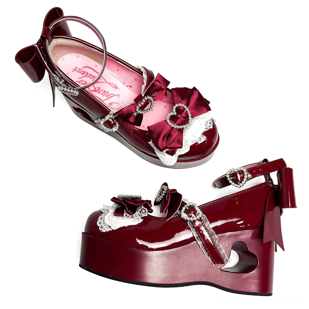 Burgundy wine-toned Jirai Kei platform Mary Jane shoe with satin bow lace trim, rhinestone buckles, and heart-cutout heel three-quarter view