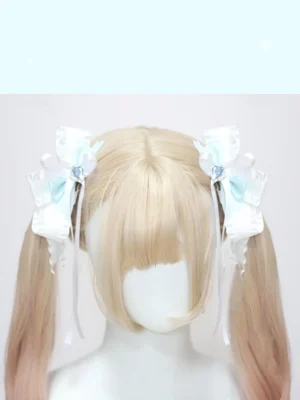 Twin ponytail hair accessory clips with ruffled satin bows and long hanging ribbon tails on blonde mannequin display