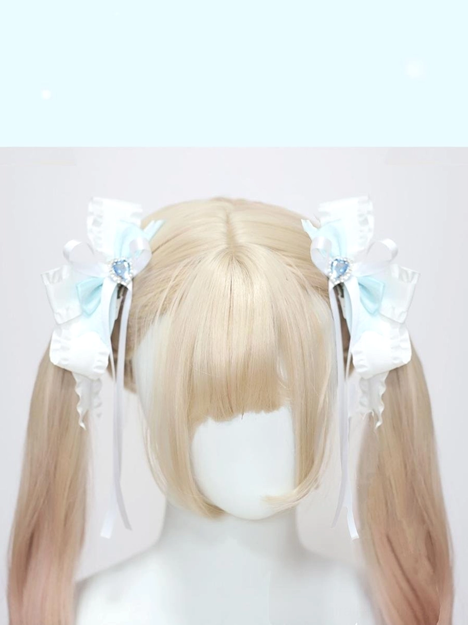 Twin ponytail hair accessory clips with ruffled satin bows and long hanging ribbon tails on blonde mannequin display