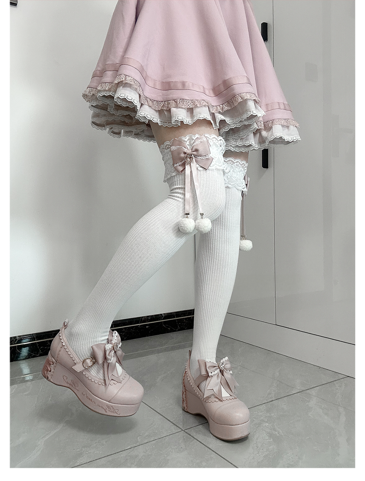 Jirai Kei black-pink mid-calf socks styling view worn with black skirt platform shoes showing proportions and visual impact of pink bow white pom-pom