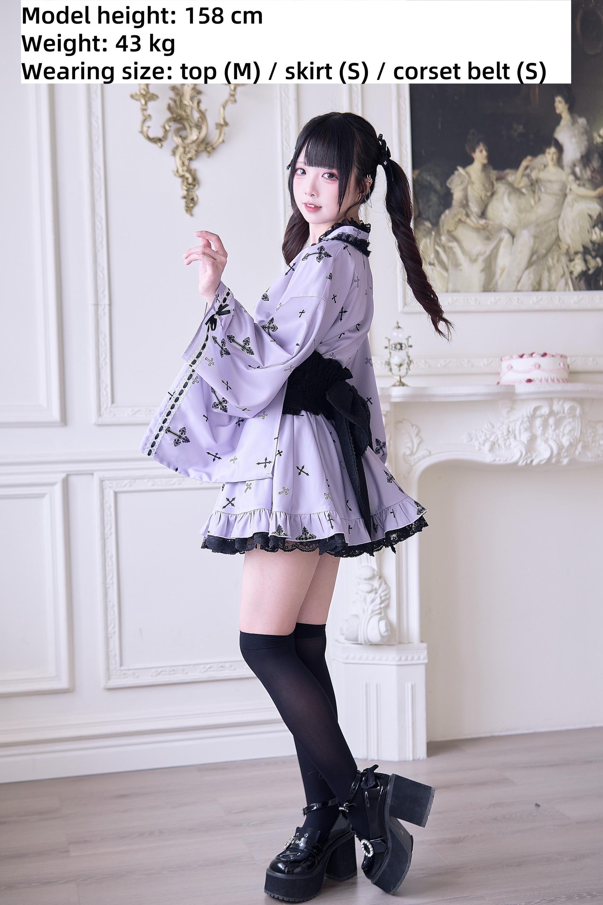 Jirai Kei kimono outfit three-quarter side profile view featuring black side bow detail, platform boots, thigh-high socks, and cross printed lavender fabric in vintage parlor interior