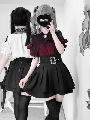 Back view mirror selfie of matching Jirai Kei two-piece sets showing white and wine-red ruffle blouse variants with identical black pleated skirts, lace capelet details, and coordinating thigh-high stockings