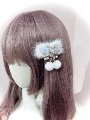 Light blue aqua satin ryousangata hair clip with pearl heart pendant and double white pom-pom drops on mannequin with straight purple bangs, jirai kei lolita accessory back view