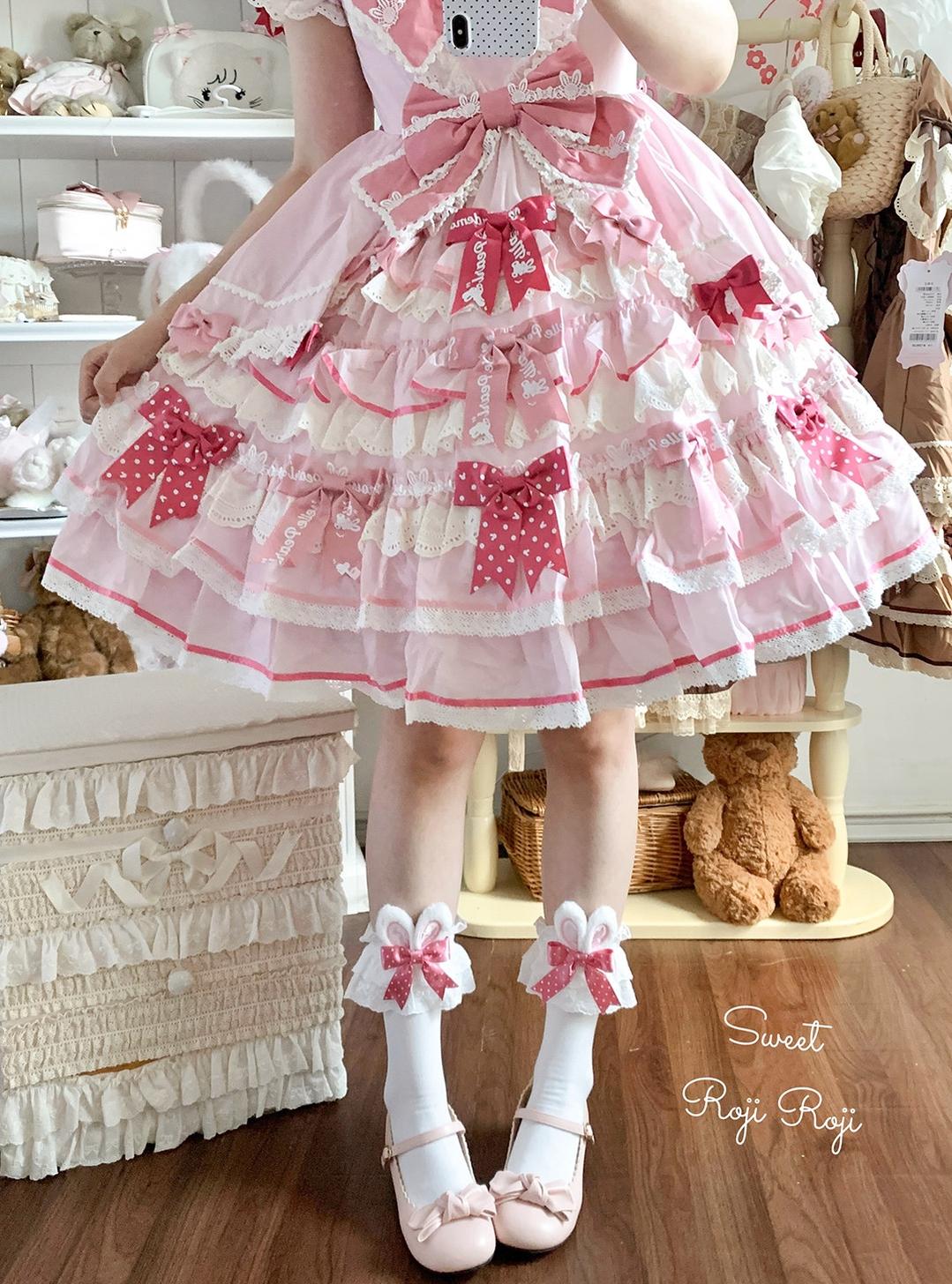 Jirai Kei pink polka dot bunny ear socks with white base worn with light pink flat shoes and pink frilled Lolita skirt in specialty shop setting