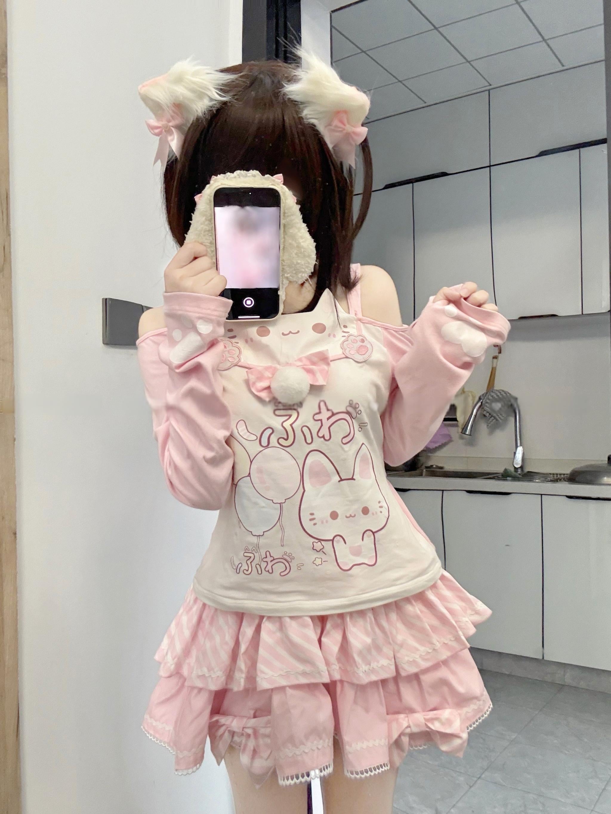 Jirai Kei cat-print off-shoulder top with white fuzzy choker and tiered multi-layer pink ruffled skirt, front full-body mirror selfie shot featuring model with cat ear hair clips and playful kawaii aesthetic styling