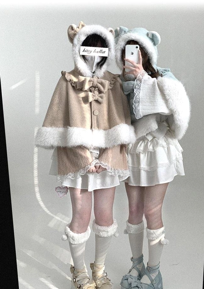 Dual model front view of cat-ear hooded cape in black-and-white and mint green colorways, featuring fluffy white trim and detachable bows in Jirai Kei aesthetic