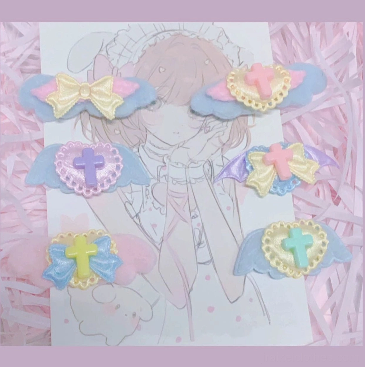 Randomly selected colorful wing hair clip in jirai kei aesthetic with vibrant iridescent rainbow wing and gothic symbol details