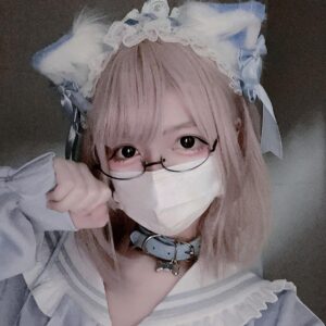 Jirai Kei cat ear lolita headdress with detachable fuzzy ears and lace trim worn by pink-haired model in front close-up selfie style