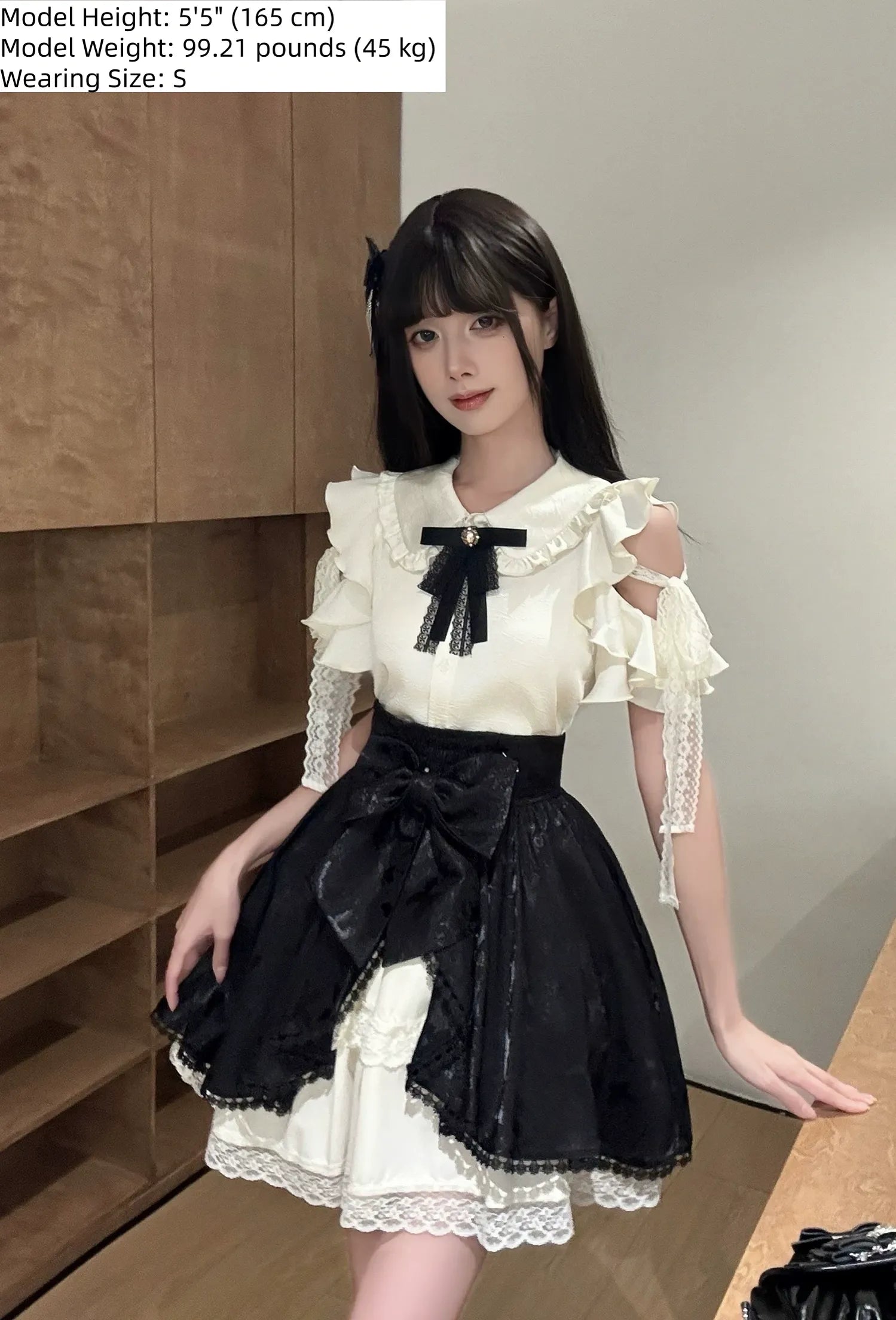 Full body front standing view of Seiso Kei blouse and butterfly skirt set featuring large front bow and elegant proportions