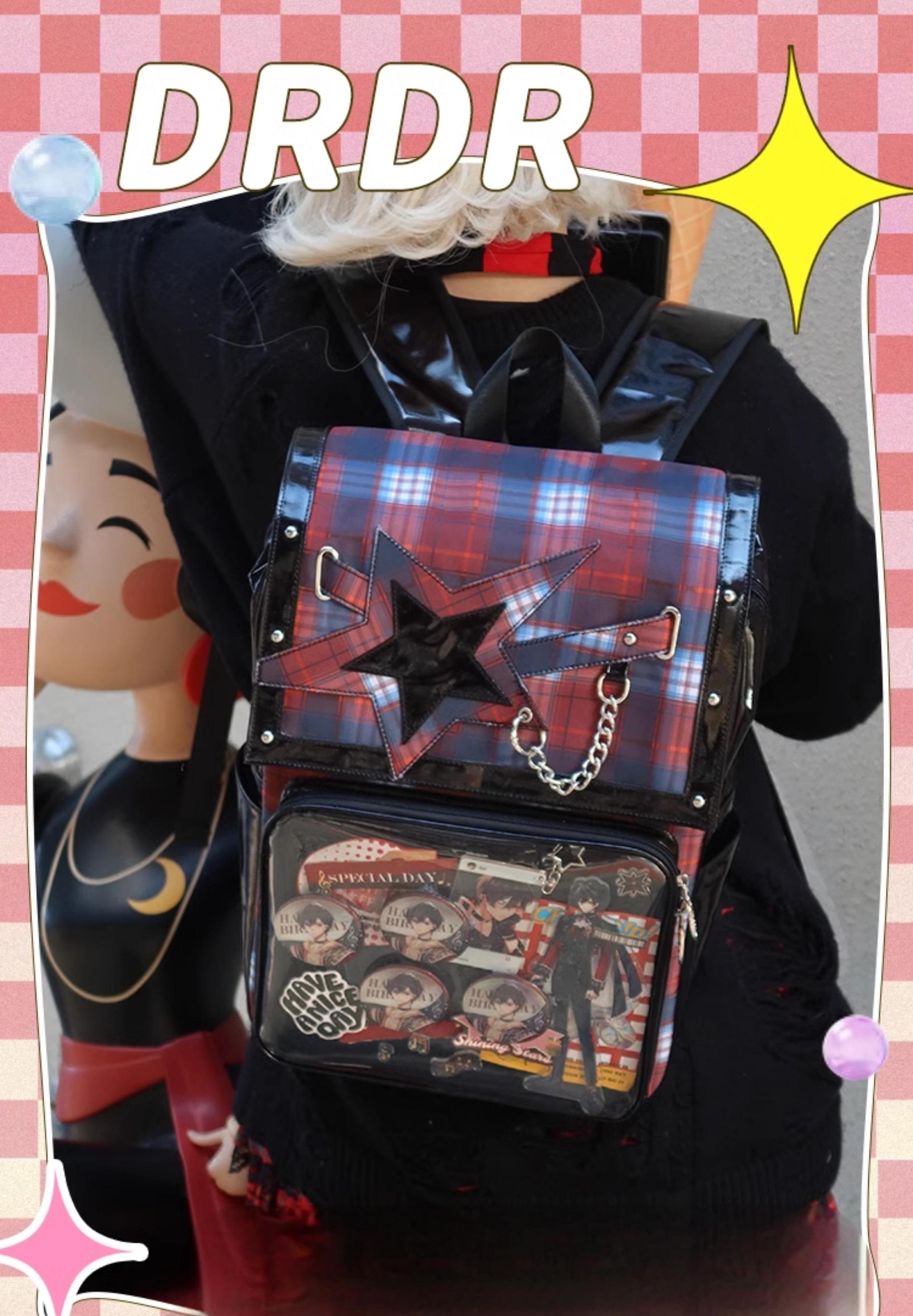 Red-black tartan star ita backpack back view worn by model with clear display window full of anime stickers