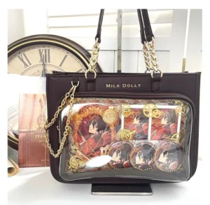 Dark brown checkered jirai kei ita bag front flat lay with anime badges and gold chain straps on vintage desktop
