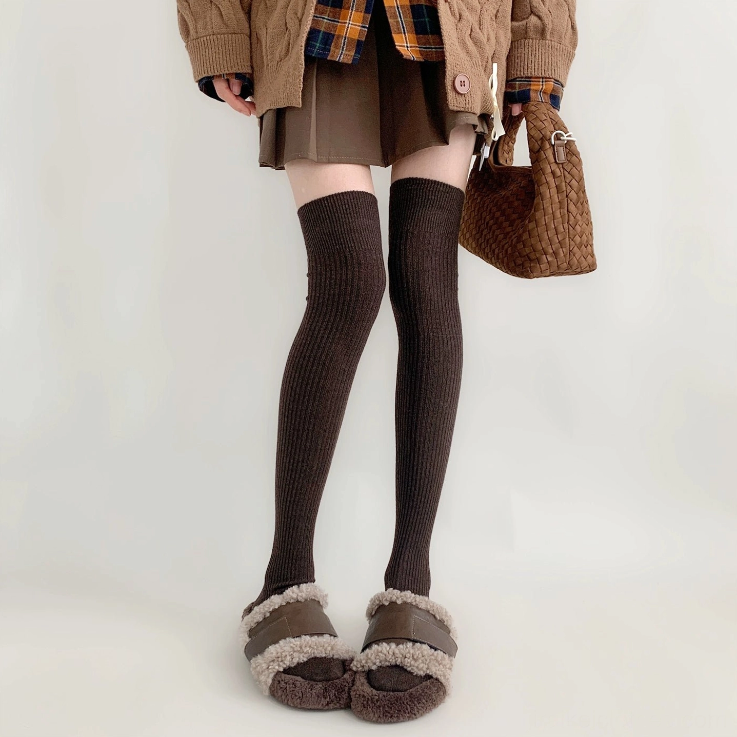 Dark brown over-the-knee ribbed socks Jirai Kei aesthetic worn with fuzzy slides brown skirt front view