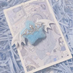 Single demon wing plush hair clip with iridescent blue star fluffy texture skull ornament and silver devil wings on anime backing card