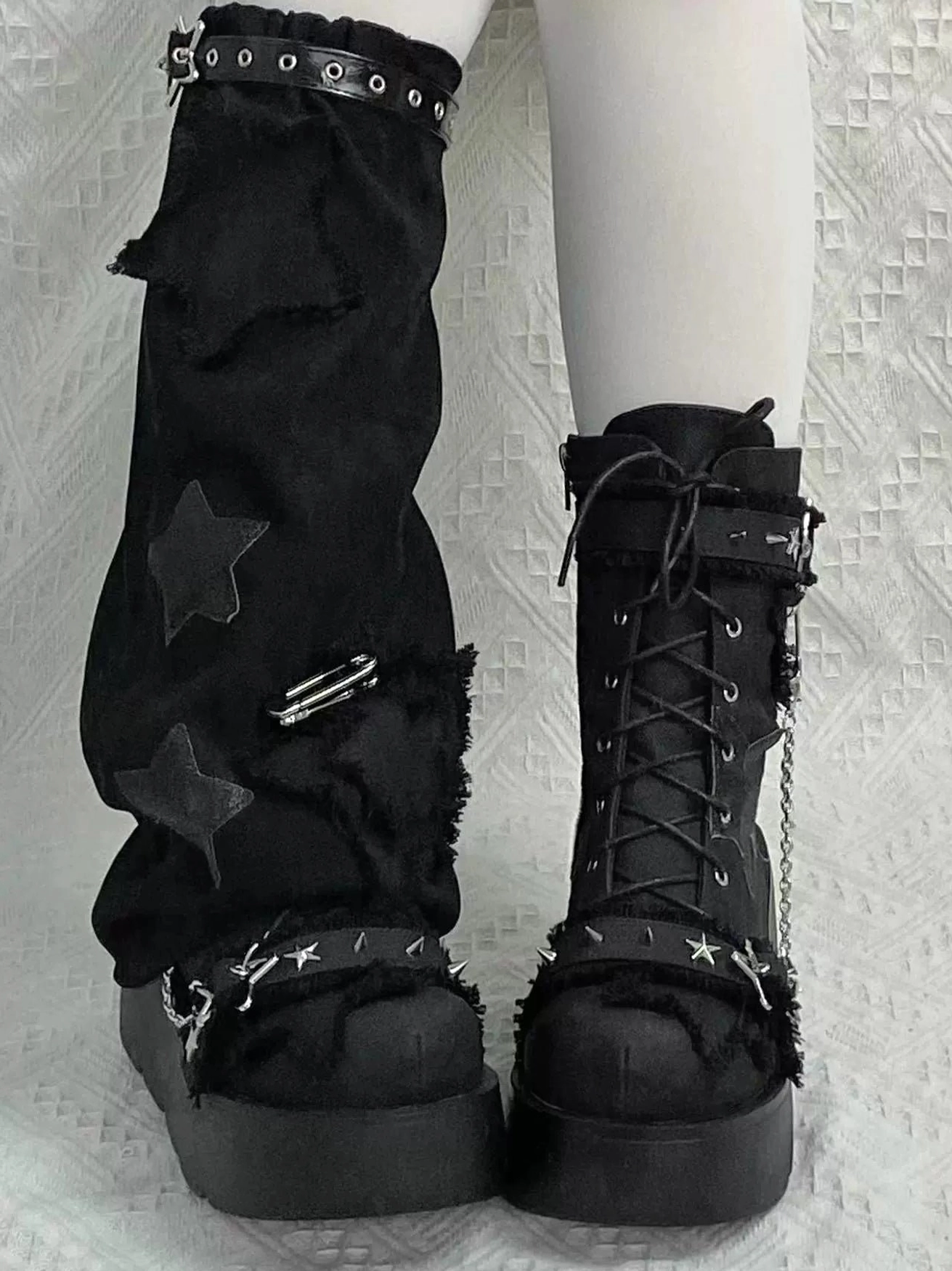 Blue denim platform combat boots front three-quarter view with frayed edges star decoration thick sole and chain straps