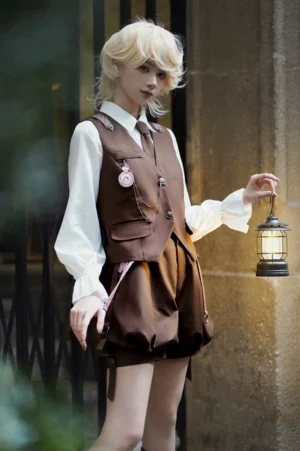 Vintage Detective Ouji Lolita complete 3-piece set worn by blonde model in outdoor street scene, featuring brown serge vest with pocket watch brooch, ruffled poet sleeve blouse, and suspender bloomer shorts with decorative straps
