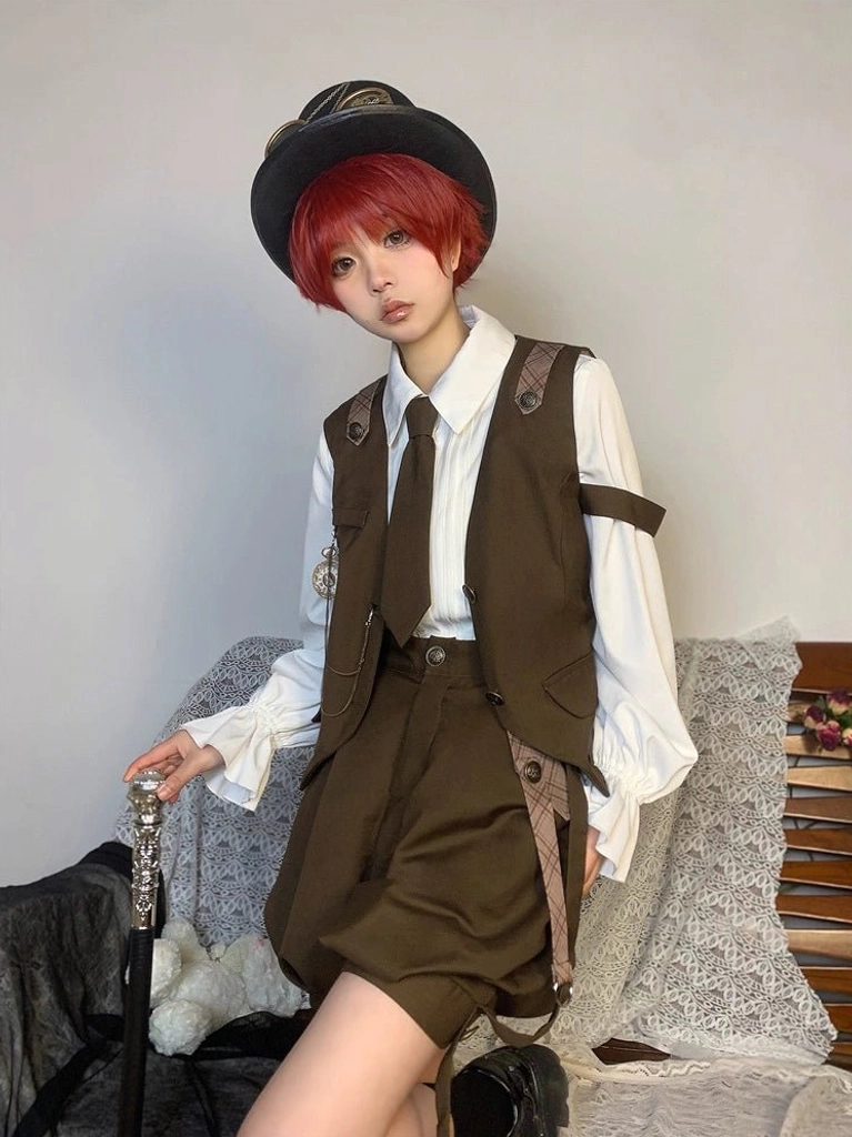 Detective Ouji Lolita suit worn by red-haired model wearing top hat on indoor sofa, featuring brown serge vest with arm straps, formal necktie, and vintage walking cane prop steampunk aesthetic