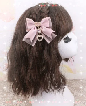 Double-layer dusty pink bow hair clip with heart crystal charm on dark brown wavy wig - Jirai Kei styling example
