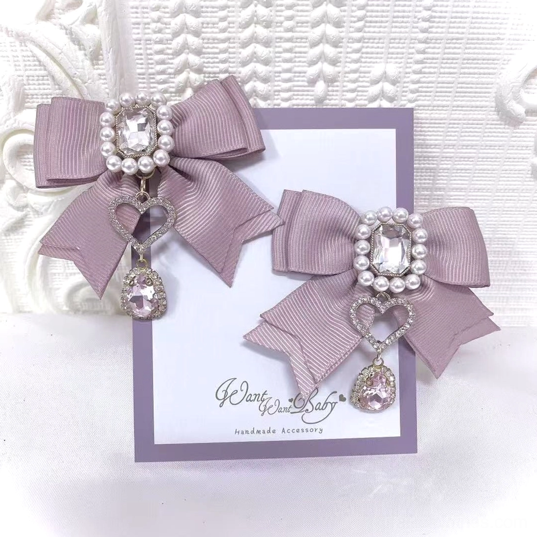 Dusty pink Jirai Kei bow hair clips carded presentation showcasing pearl rhinestone embellishment and heart link crystal charm