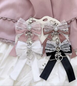 Ryousangata bow bag pendants collection featuring multiple color variations with heart rhinestone charm details and lace trim - Gray-blue light lotus pink dark lotus pink and white bow charms for Jirai Kei aesthetic