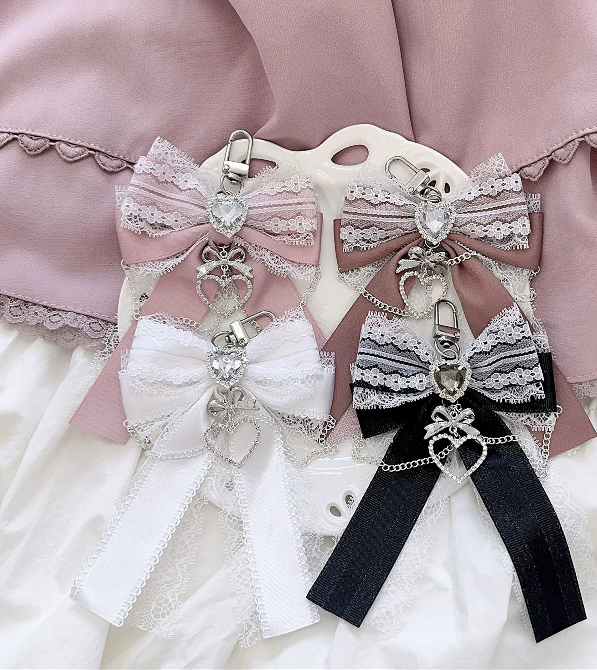 Ryousangata bow bag pendants collection featuring multiple color variations with heart rhinestone charm details and lace trim - Gray-blue light lotus pink dark lotus pink and white bow charms for Jirai Kei aesthetic