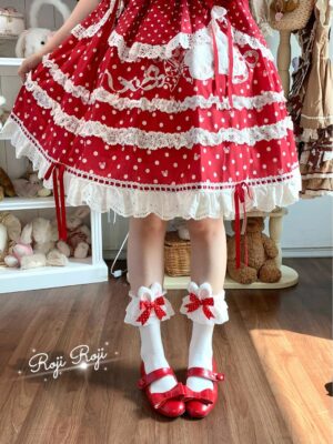 Jirai Kei red polka dot bunny ear socks with white base worn with red Mary Jane shoes and red frilled Lolita skirt in specialty shop setting