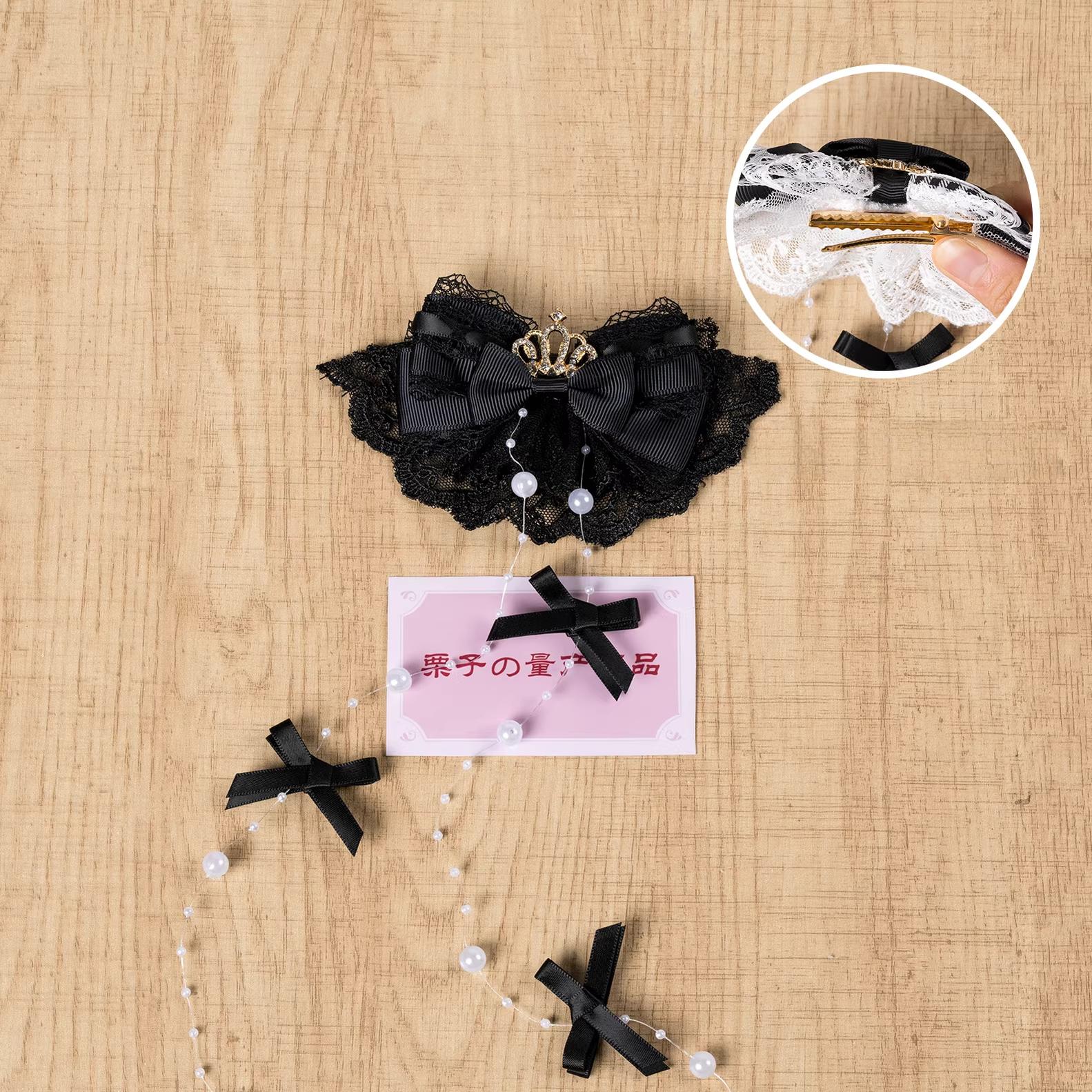 Pure black gothic Jirai Kei hair clip with intricate lace bow, rhinestone crown accent, and pearl tassel chains - left-facing