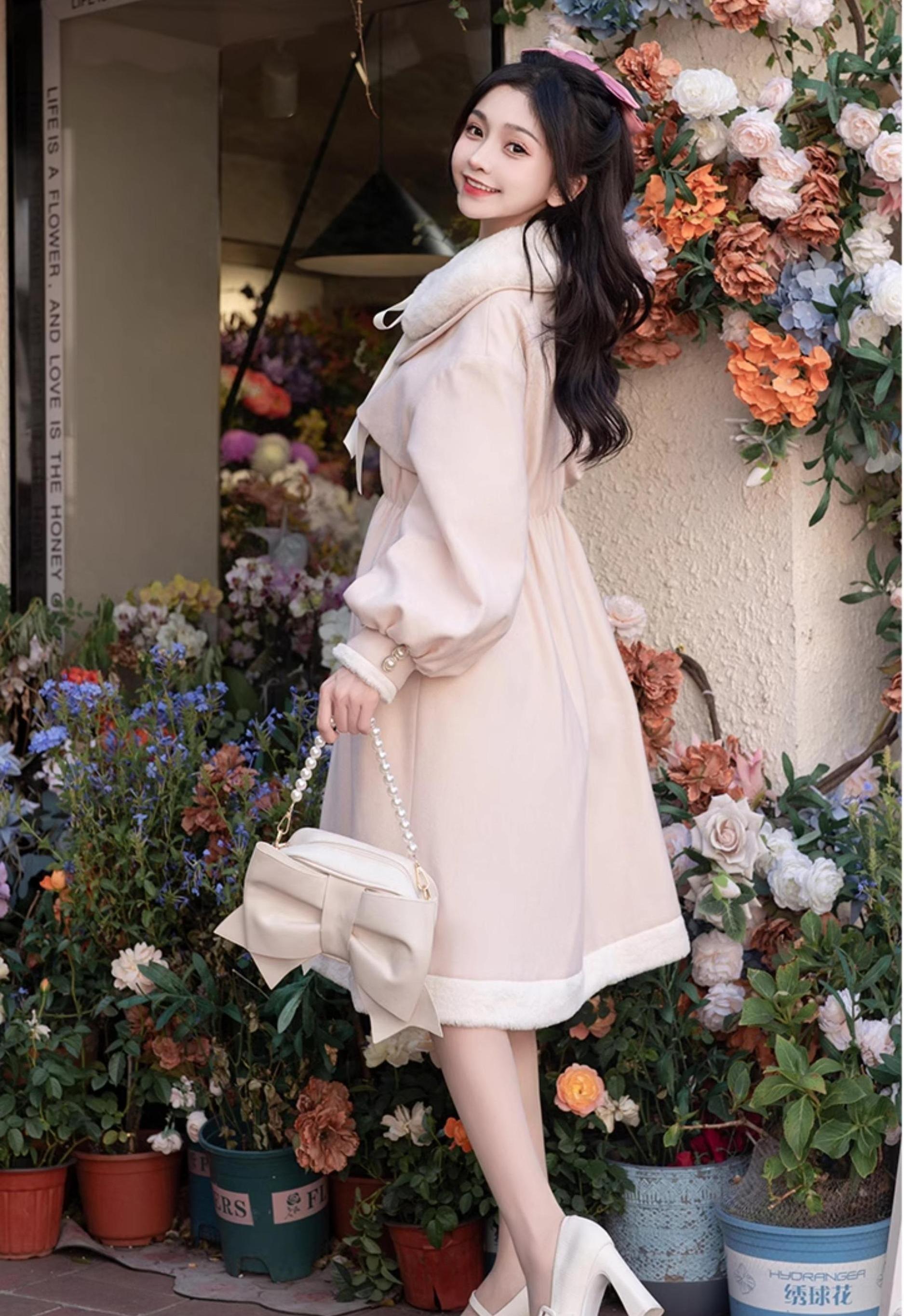 Light pink Ryousangata Jirai Kei winter coat side profile - girl with half-up hairstyle wearing pink coat with fuzzy hem trim, lantern sleeves, and delicate mid-length design