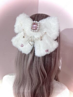 White fuzzy ryousangata bow hair clip with pink rhinestone center and pearl heart chain, back view on model with light brown hair, jirai kei aesthetic accessory