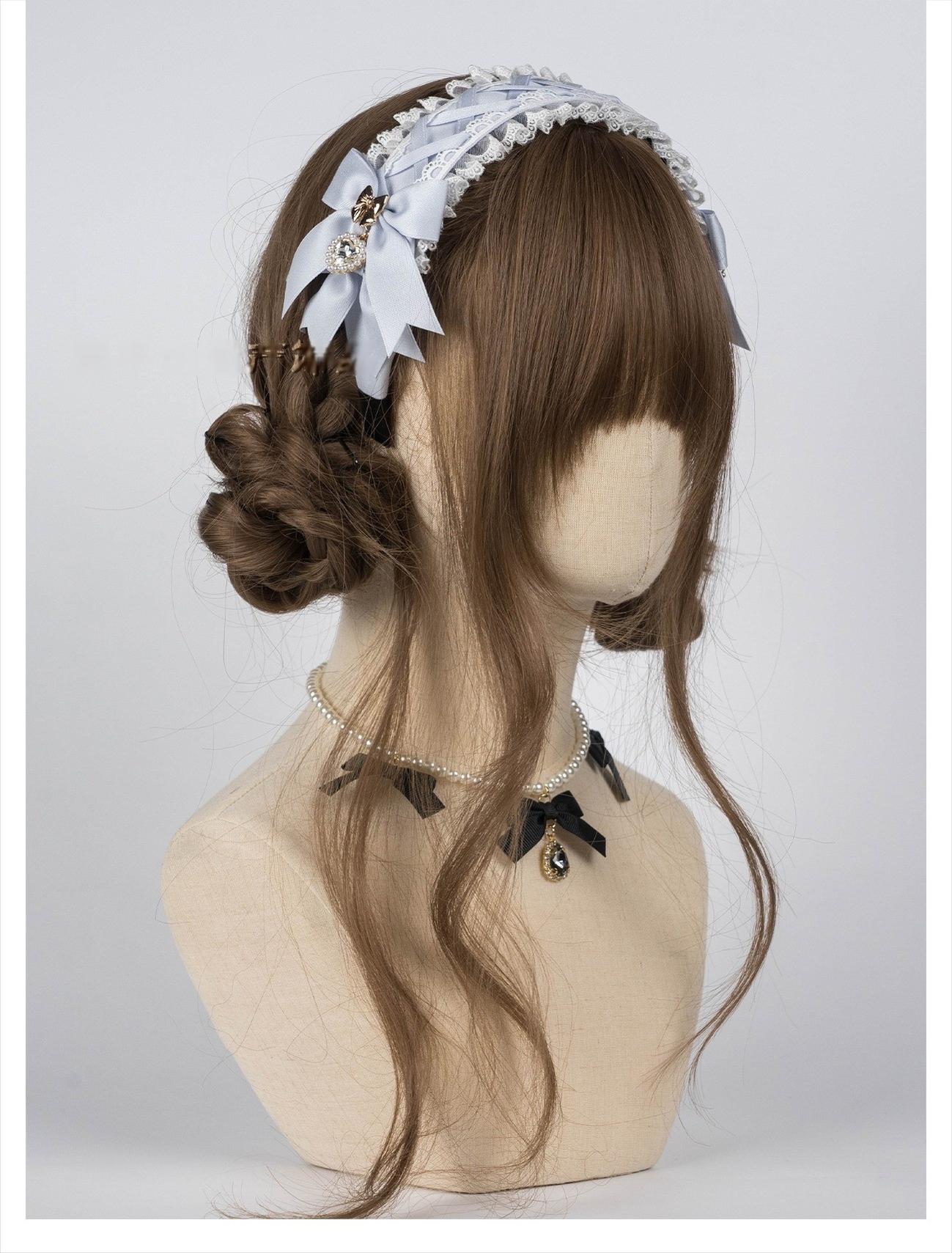 Gray-blue Jirai Kei lace headband with ruffled lace construction and rhinestone heart pendants styled on mannequin with brown curly bun wig, demonstrating comfortable fit and elegant aesthetic