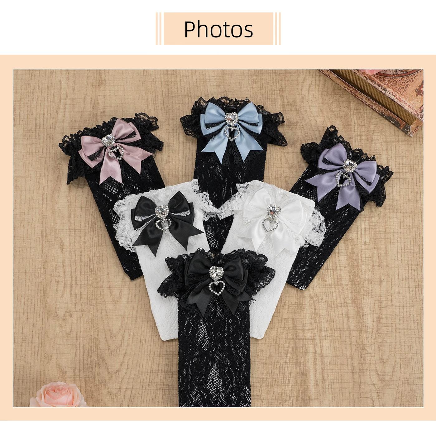 White lace knee-high Jirai Kei socks with ruffled white lace cuff, white bow and heart rhinestone accent, full length front view