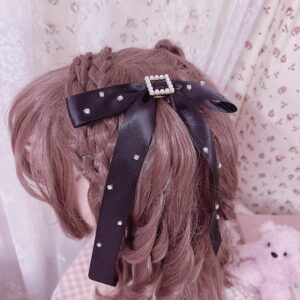 Black satin bow hair clip with pearl-rimmed square rhinestone center accent worn on mannequin, demonstrating Jirai Kei luxury hair accessory design with dangling ribbon details