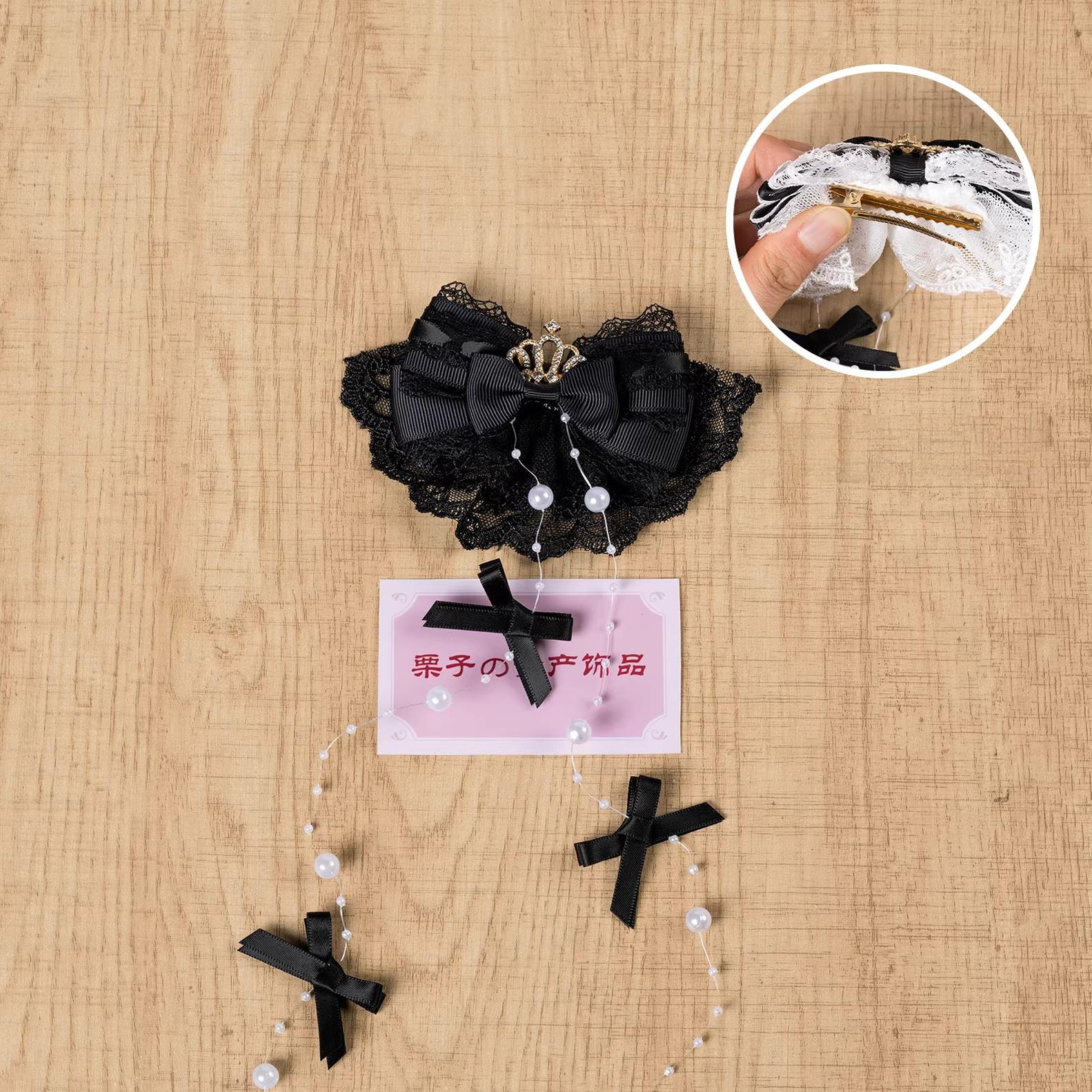 Pure black Jirai Kei hair clip with gothic lace bow, rhinestone crown accents, and pearl tassel - left-opening variant
