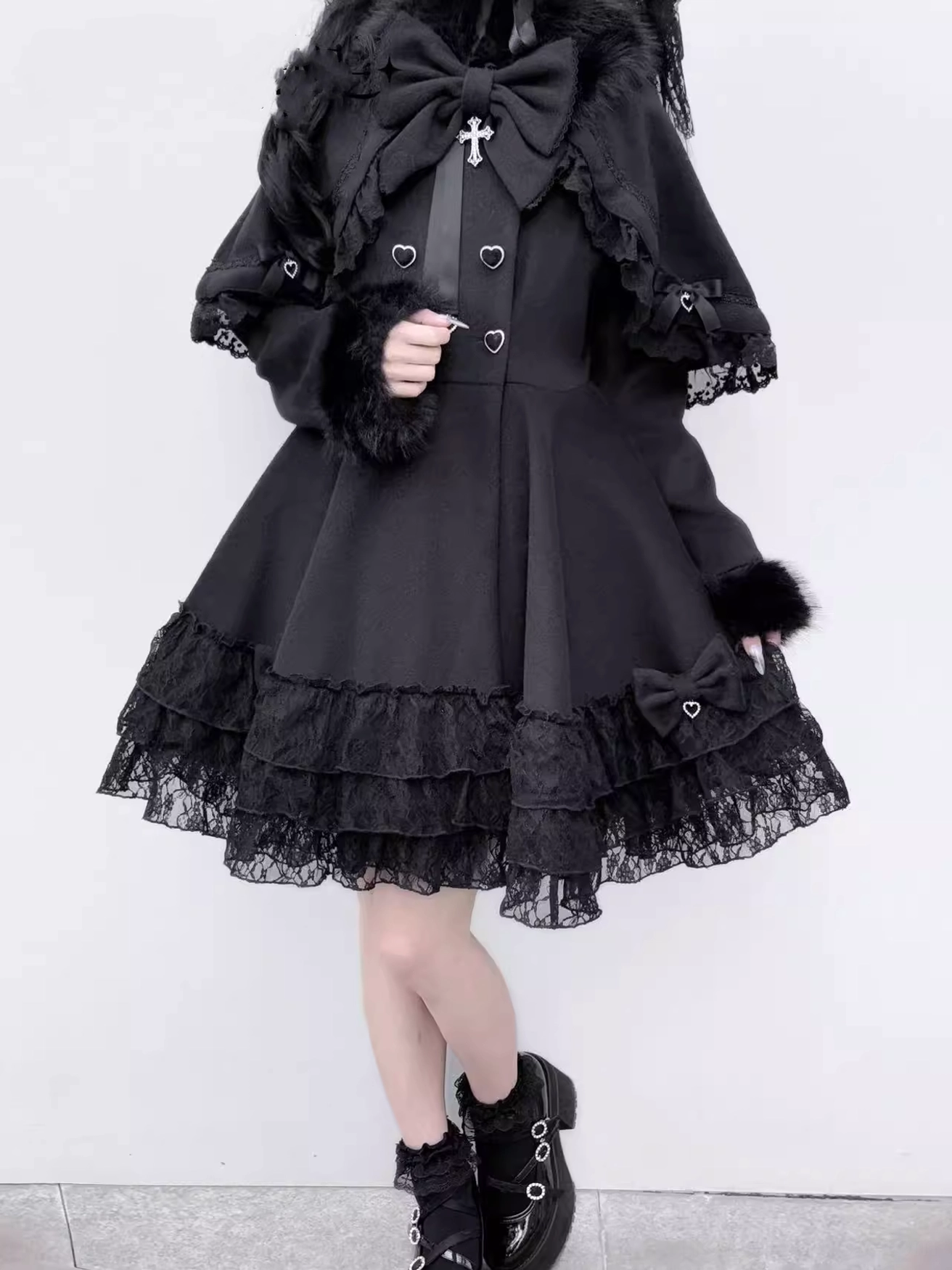 Full body right side view of gothic Jirai Kei detachable cape coat with fur cuffs, layered lace skirt, and removable cape with bow design