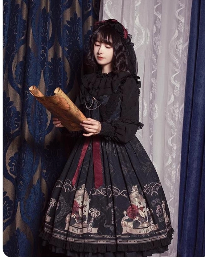 Black gothic lolita dress side view with red waist bow and printed skirt detail