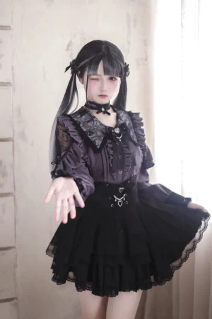 Gothic Lolita tiered ruffled skirt and lace top two-piece ensemble, model wearing purple lace top with black multi-layer ruffled skirt, Jirai Kei aesthetic, three-quarter front view