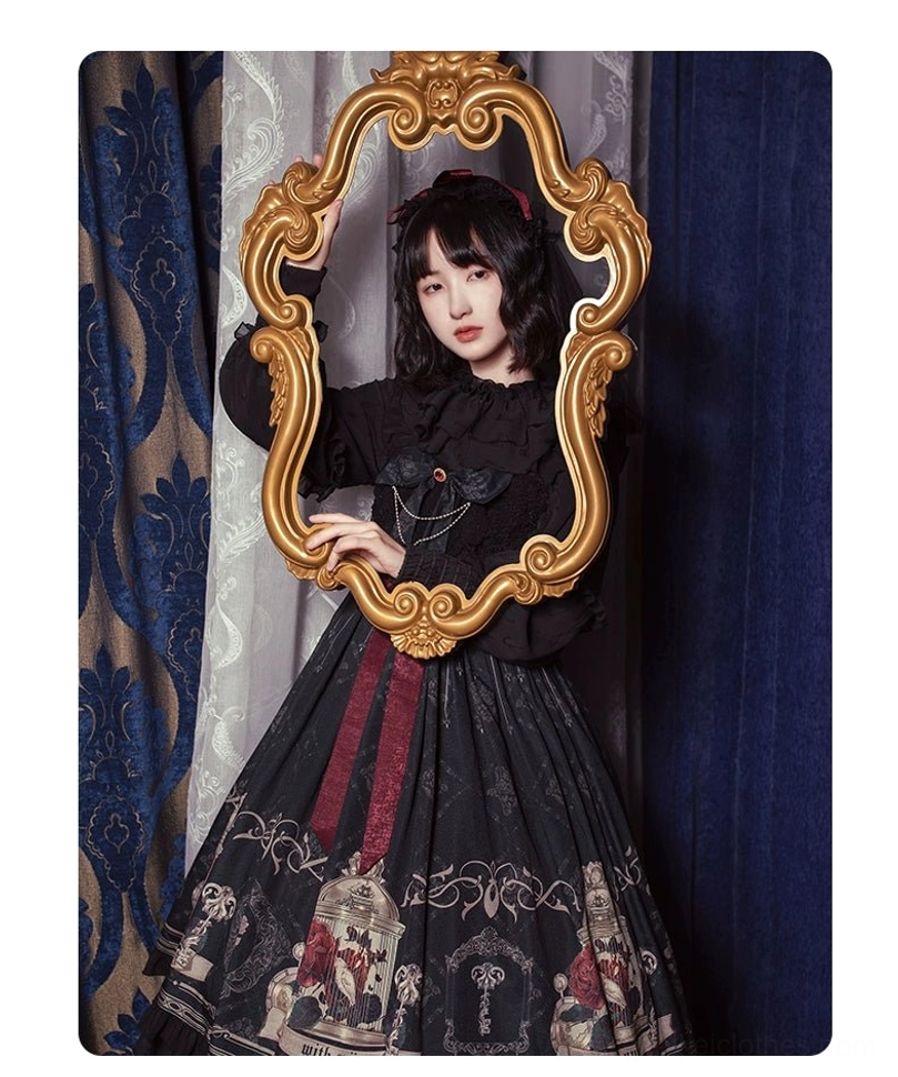Gothic lolita jsk dress half body shot showing ruffled sleeves chain accessories birdcage print
