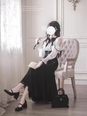 Black mermaid skirt white off-shoulder blouse three-quarter sitting pose model holding book vintage armchair gothic lolita fashion
