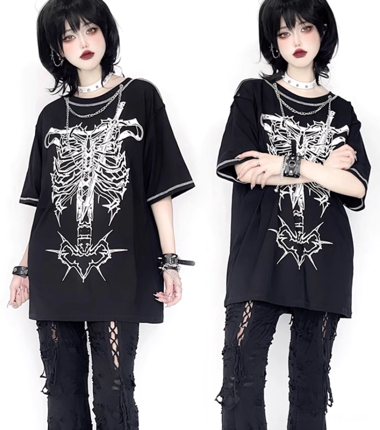 Black oversized gothic T-shirt with ribcage dagger print worn with ripped black pants and punk bracelets studio styling